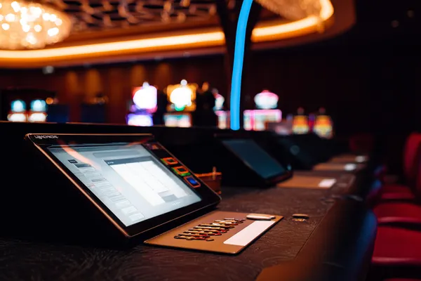 GOOD111 Games — Discover modern slots and table adventures A man celebrating a winning moment on his laptop while gaming symbols float around him, capturing the excitement of GOOD111 games.